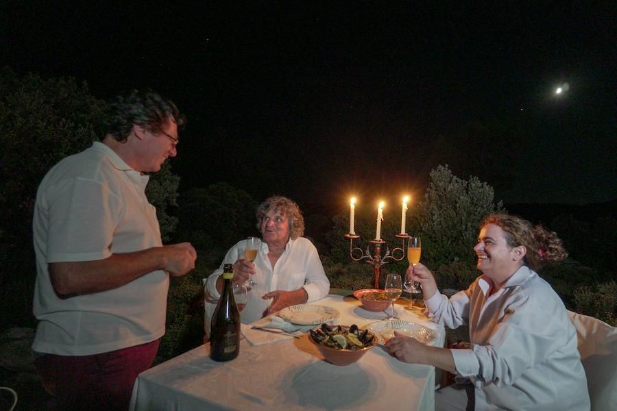 a couple having a romantic dinner under the moonlight and talking with a guide of Afianes wines