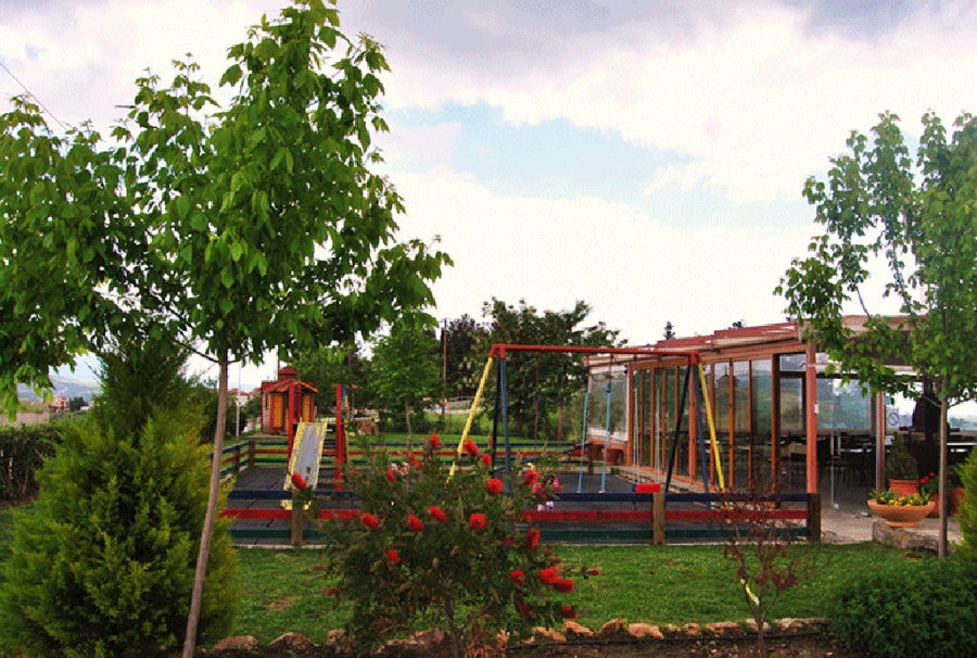 'Agios Antonios Women’s Agri Cooperative' play garden and surrounded by trees