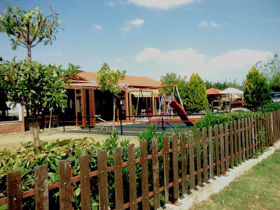 'Agios Antonios Women’s Agri Cooperative' complex with play garden and surrounded by wooden fence