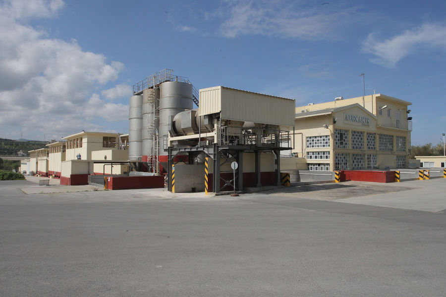 front view of 'Alexakis Winery' with outside tanks in the background of blue sky