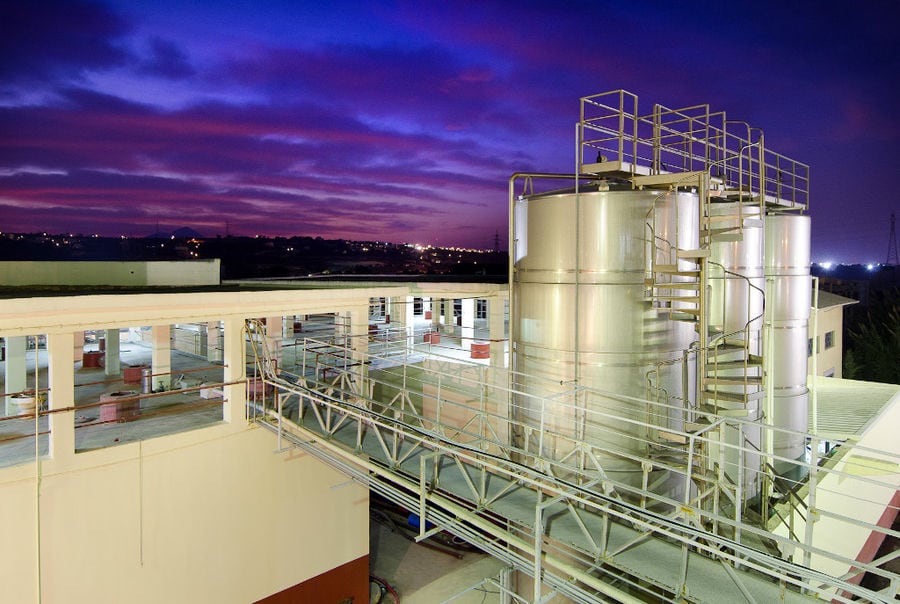 view of the outside aluminum wine storage tanks at 'Alexakis Winery' plant by night