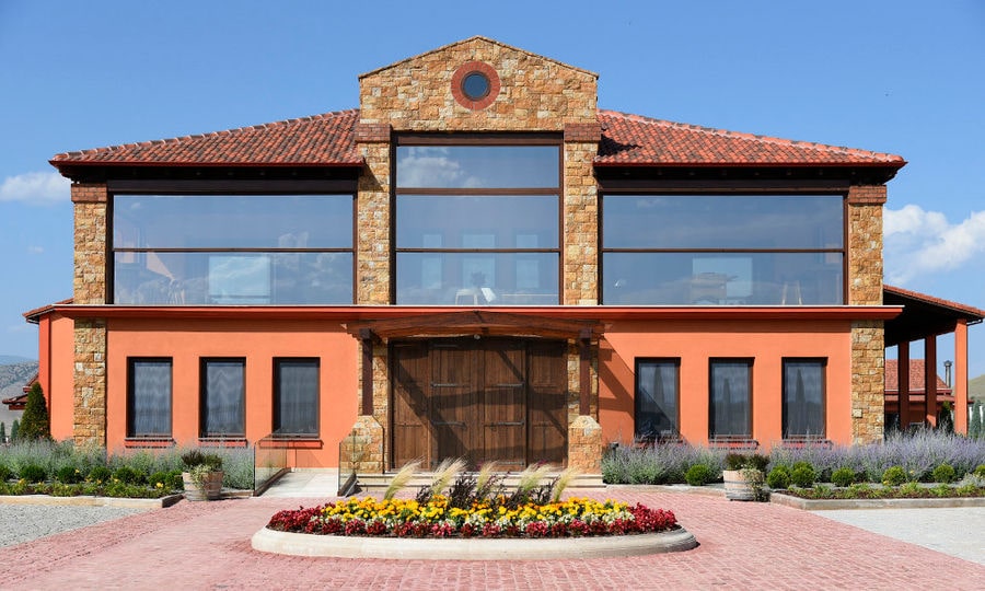 Alpha Estate entrance outside with stone pavement and flowers in the front