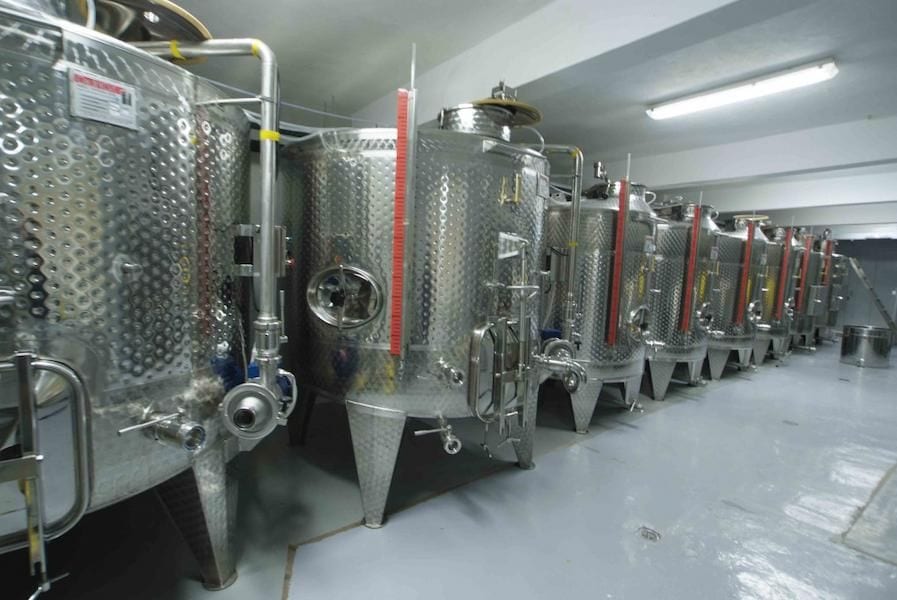 aluminum wine fermantation tanks in line inside at Afianes wines