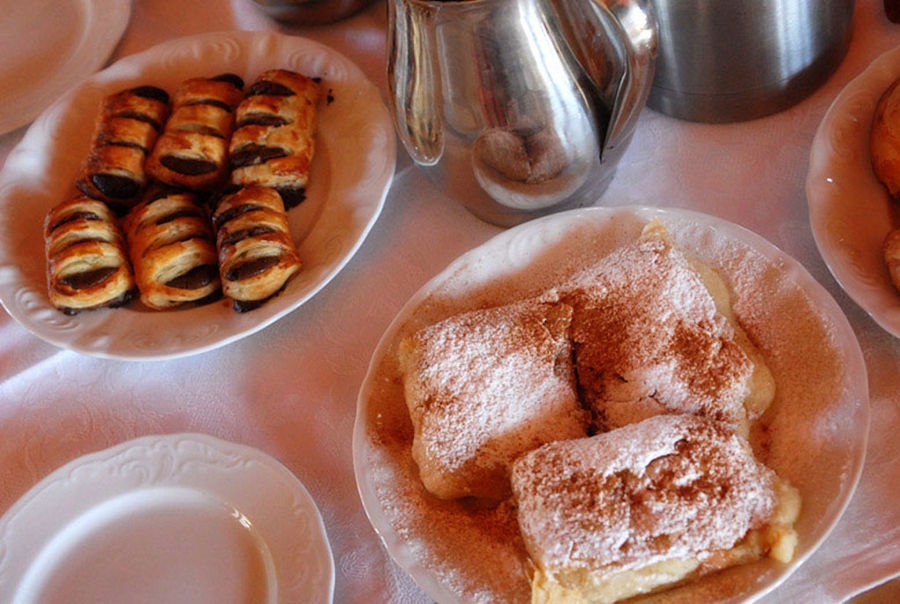 plates with croissanta and pieces of pies at Amfikaia