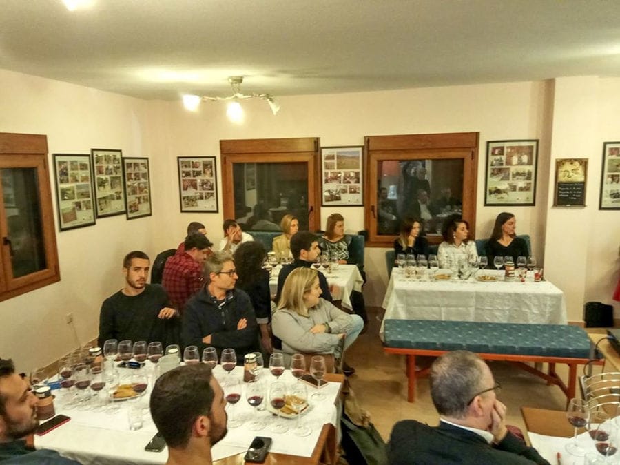 tourists tasting wines and listening to a guide at 'Argatia Winery'