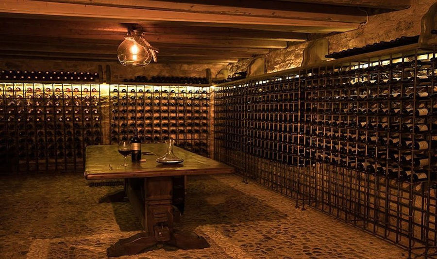 Argyriou Winery cellar with stacked bottles on top of each other in the storage frame