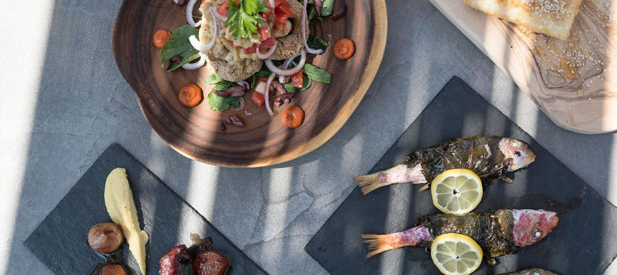 plates from above with cooked fish and salad from 'Astarti'