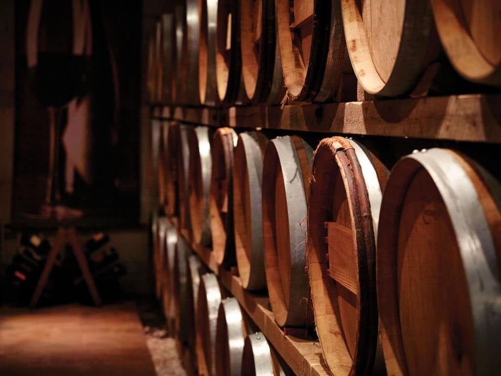 wooden barrels on top of each other at ‘Avantis Estate’ cellar that recognized with many awards|