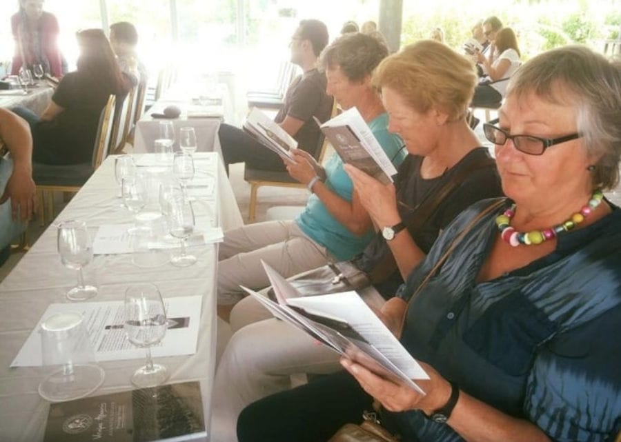 tourists aroun the table, tasting the wines of Avantis Estate