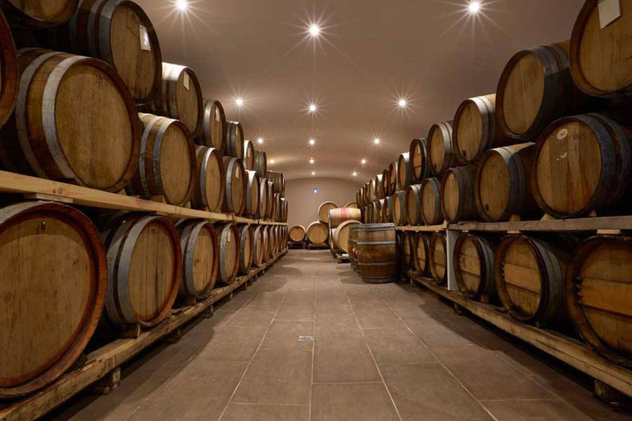 wood barrels on top of each other in 'Artemis Karamolegos Winery' cellar