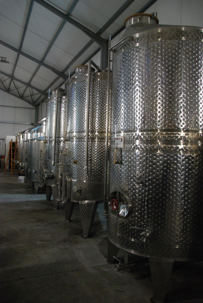 lying aluminum wine storage tanks at 'Belidis Vineyards' plant