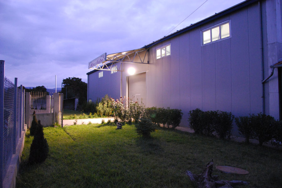 illuminated building at 'Belidis Vineyards' by night with lawn grass in the front