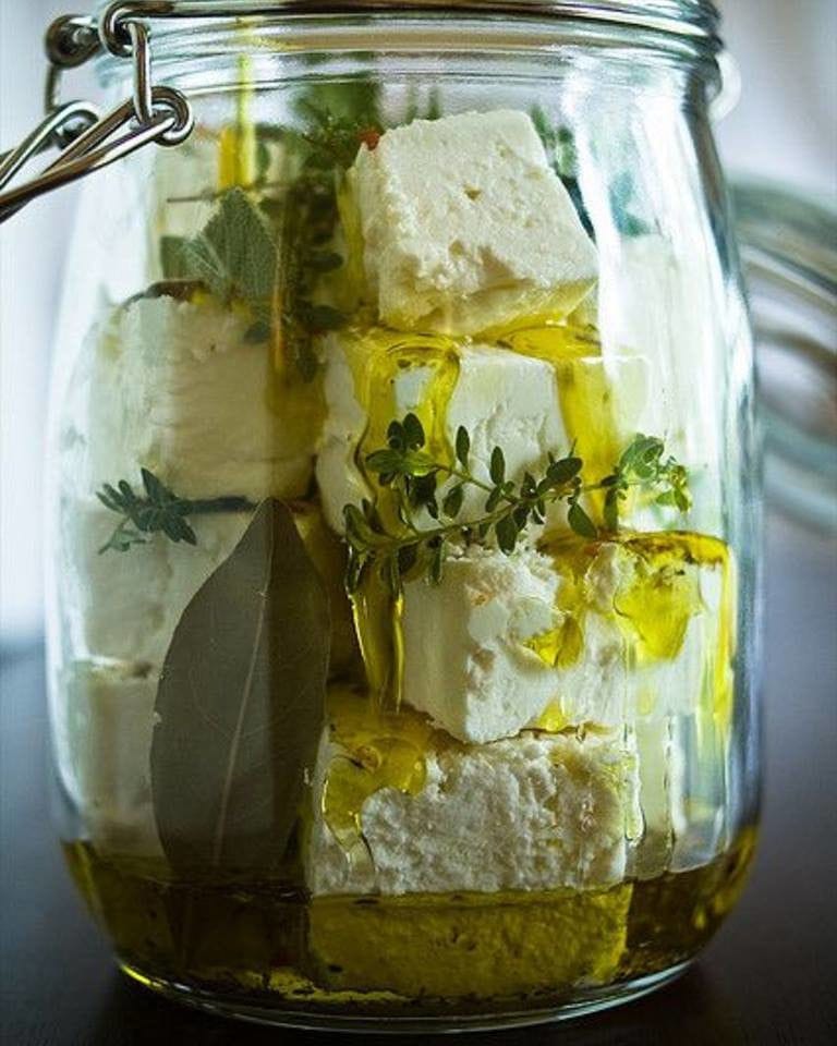 jar with white cheese, oil and herbs at Ben Olive Mill