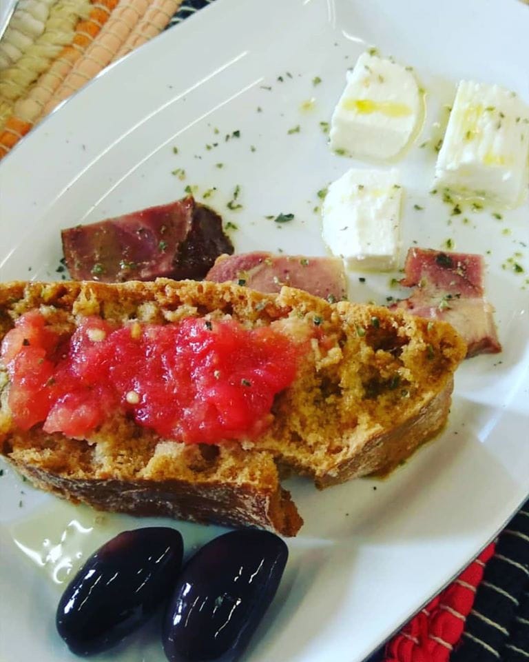 plate with bread, white cheese, meet, black olives and tomato from Ben Olive Mill