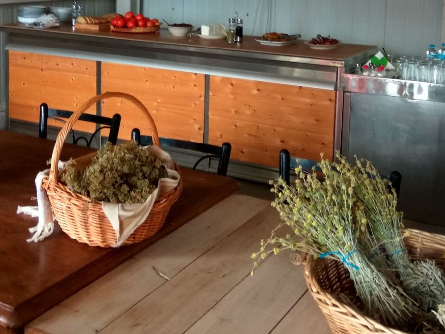 baskets with dry herbs on the wooden tables at Bio Goupios