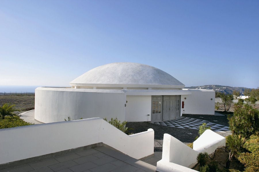 one side of the white building with cupola of Boutari Santorini Winery