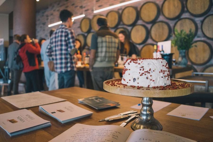 cake on background of tourists tasting wines at Semeli Estate winery