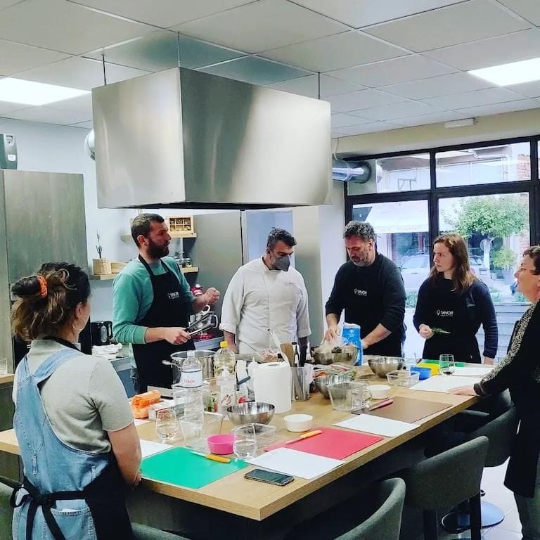 chef giving a cooking lesson to a group of people at Savor Nafplio