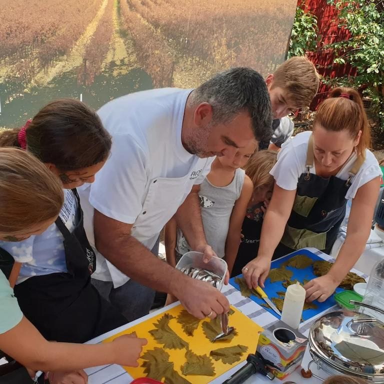 chef giving a cooking lesson to a group of people at Savor Nafplio