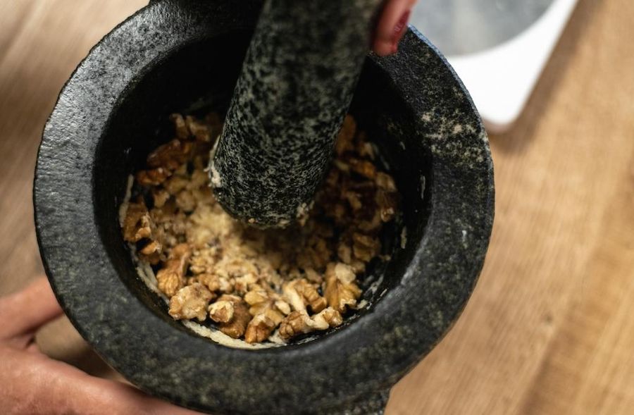 close-up of a chef using manual nut crusher at Savor Nafplio