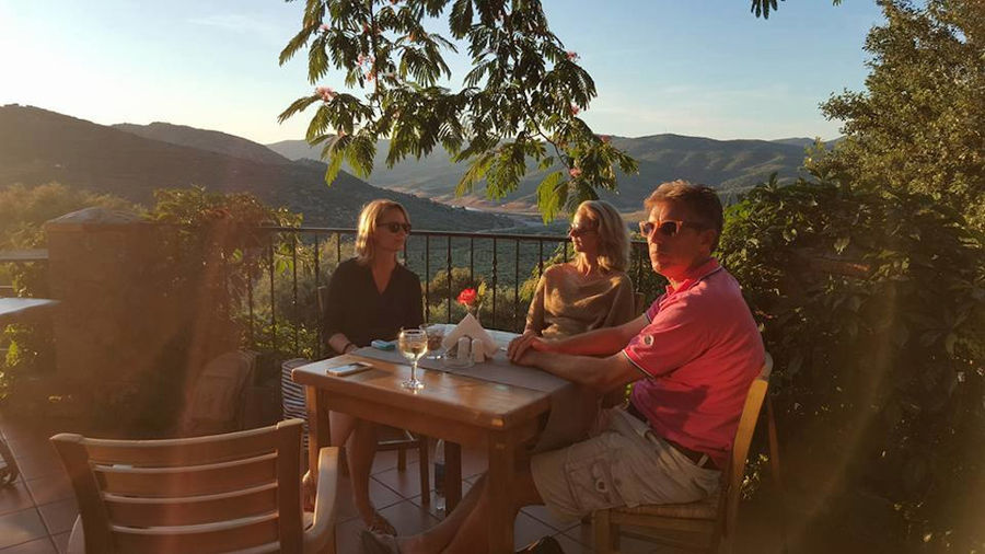 tourists sitting at the table enjoy the sun shine at Country Hotel Velani