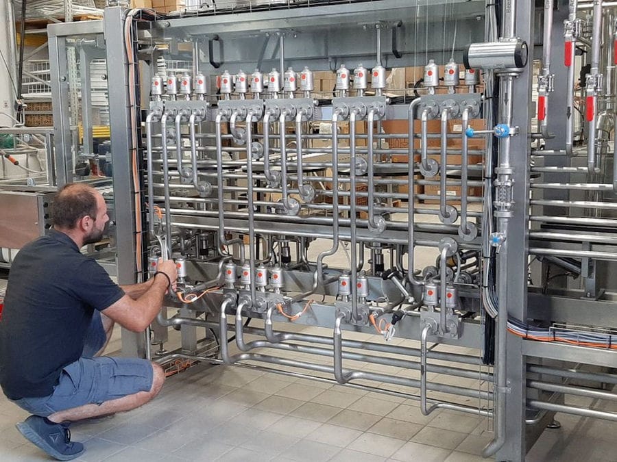 man doing maintenance work of beer brewing system at Cretan Brewery plants