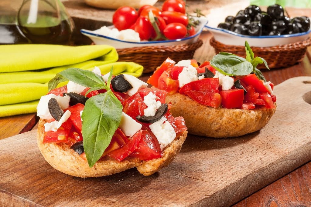 'paximadi' dry rusks with cheese and fresh tomato on top is Secrets of the Cretan Diet