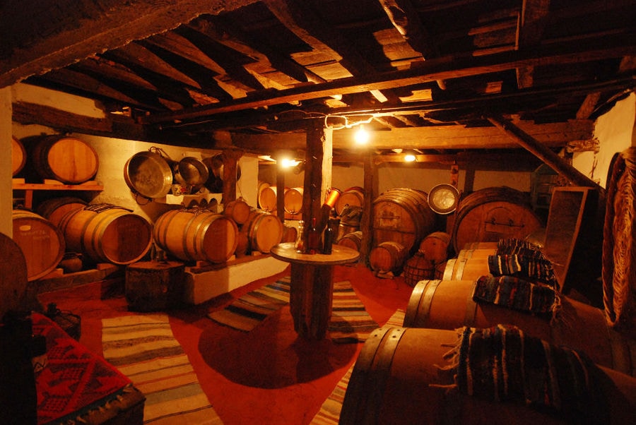 exhibition folklore room with wood ceiling at 'Dio Fili' with old wine barrels and traditional carpets