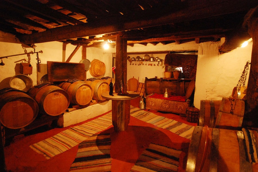 exhibition folklore room with wood ceiling at 'Dio Fili' with old wine barrels and traditional carpets