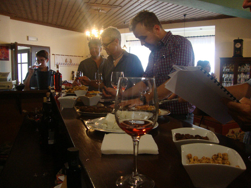 tourists tasting wines and eating snacks at 'Dio Fili' bar