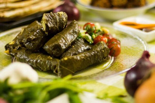 Close-up of plate with Greek ‘Dolmadakia’ means stuffed vine leaves