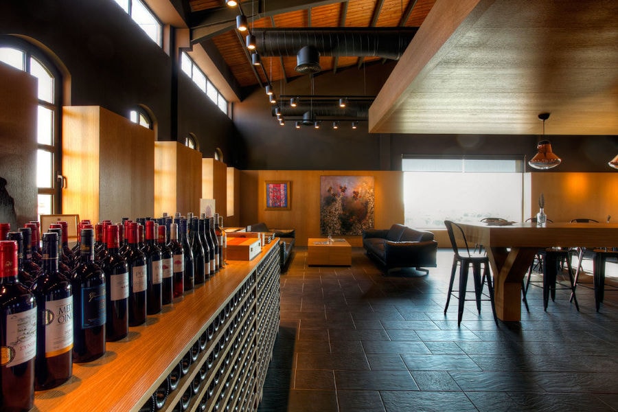 wine tasting room with tables, chairs and leather couches of 'Domaine Skouras' winery
