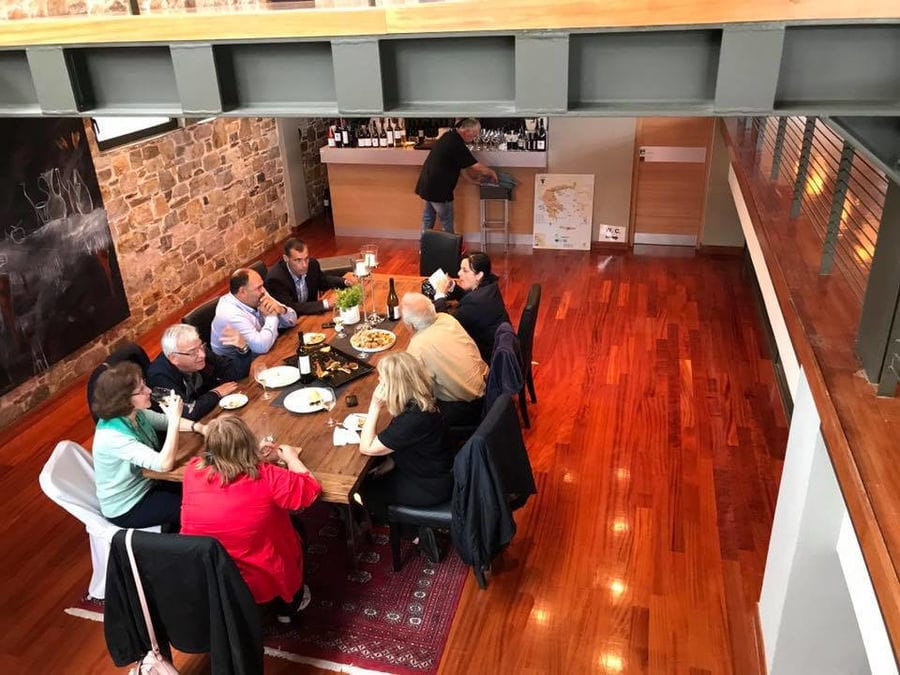 view from above of tourists tasting wines at 'Domaine Papagiannakos' winery