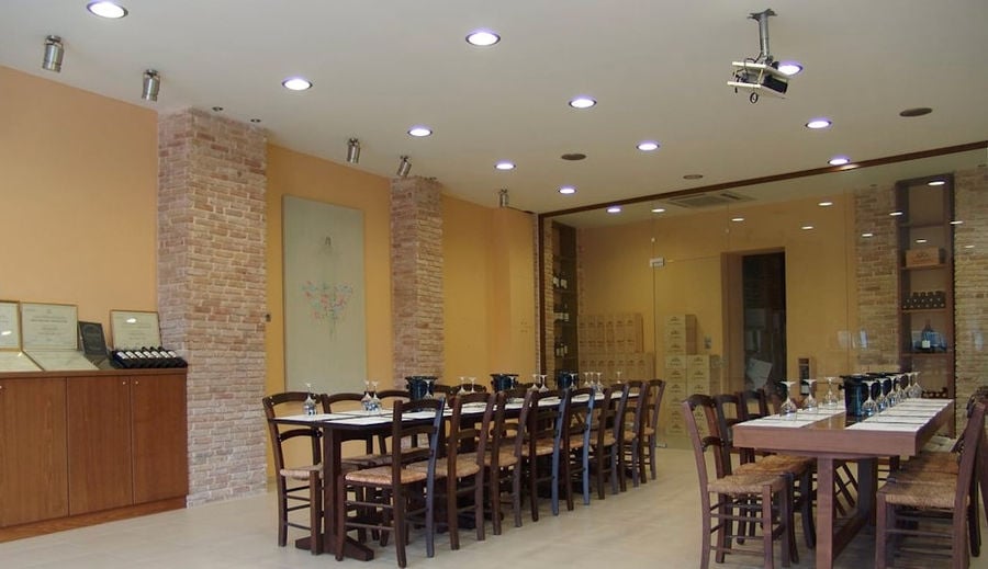 Douloufakis Winery tasting room with wood tables and chairs