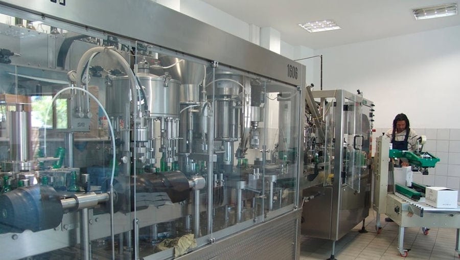 man working to wine packaging machine at Douloufakis Winery plant