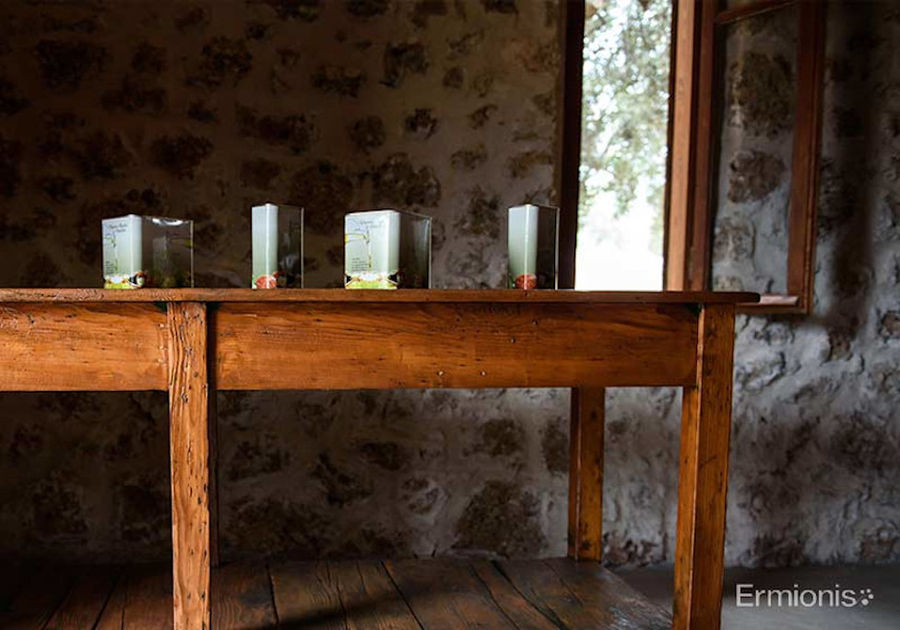 wooden table with oil cans on the top at 'Olive Oil Museum, Ermionis Bairaktaris Apiary'