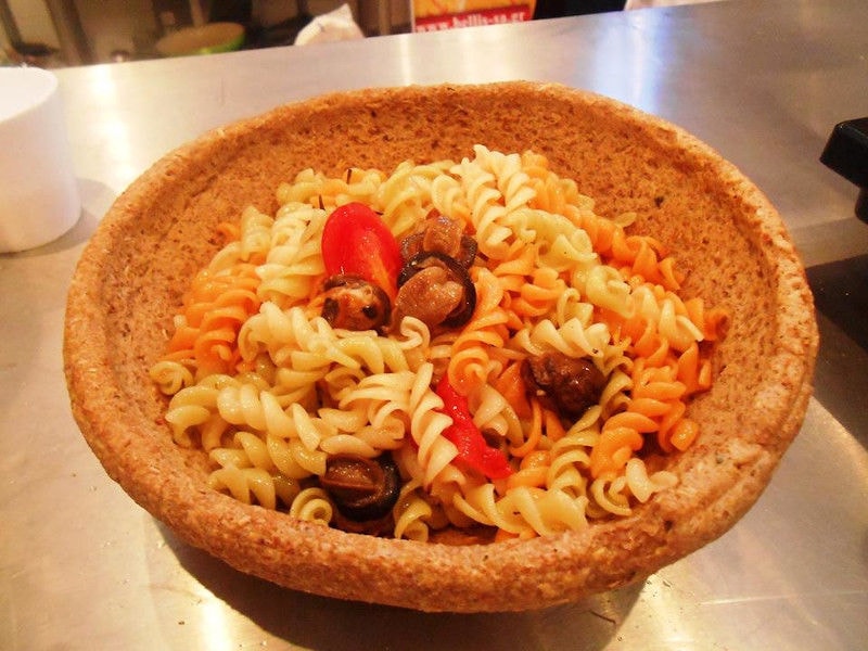 pot with cooked fusilli pasta with snails and tomato sauce from Escargot de Crete farm
