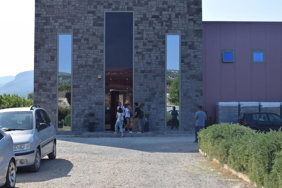 tourists at Constantin Gofas Estate entrance outside with stone pavement