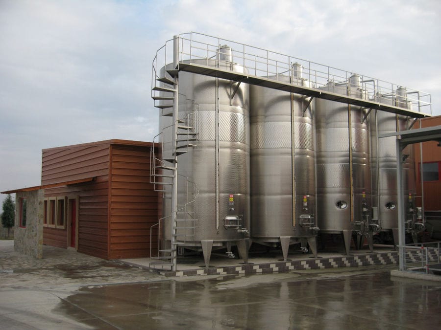 lying outside aluminum wine storage tanks at 'Evritika Kellaria' facilities