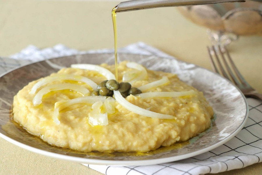 Close-up of plate with Greek ‘fava’ and oil flowed from the aluminum bottle on the food like mashed potatoes