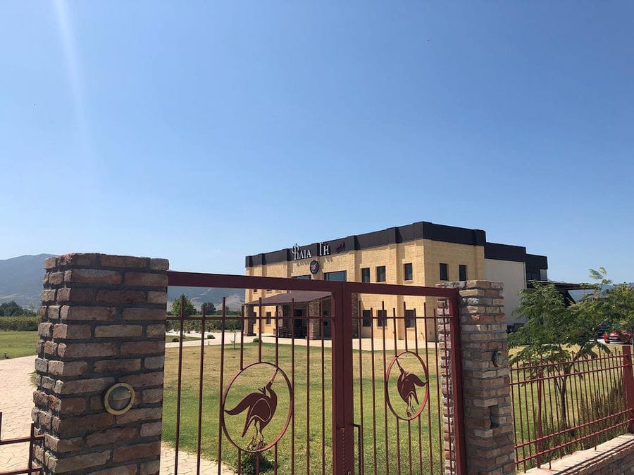 outsite 'Filia Gi' entrance with ornamental wrought iron gate with flowers and two stone columns