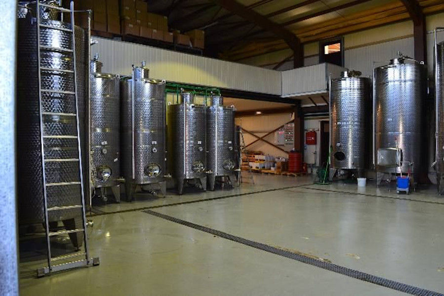 lying aluminum wine storage tanks by the walls of 'Filia Gi' plant