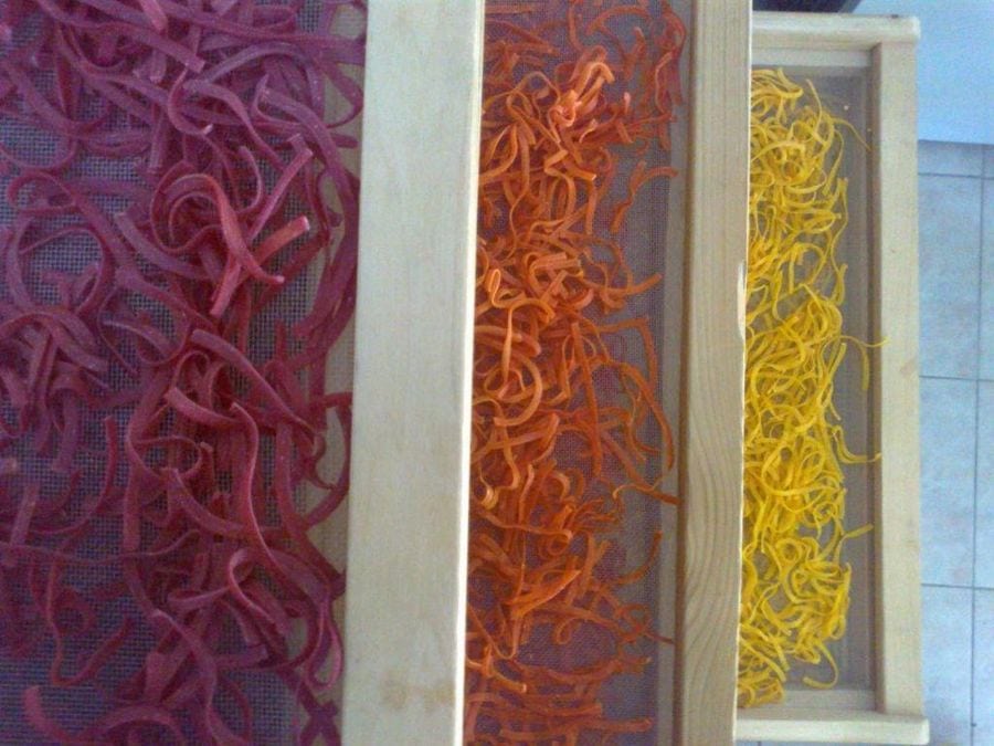 wood frames with multicolor hilopites pasta on top of each other at Thracian Pasta