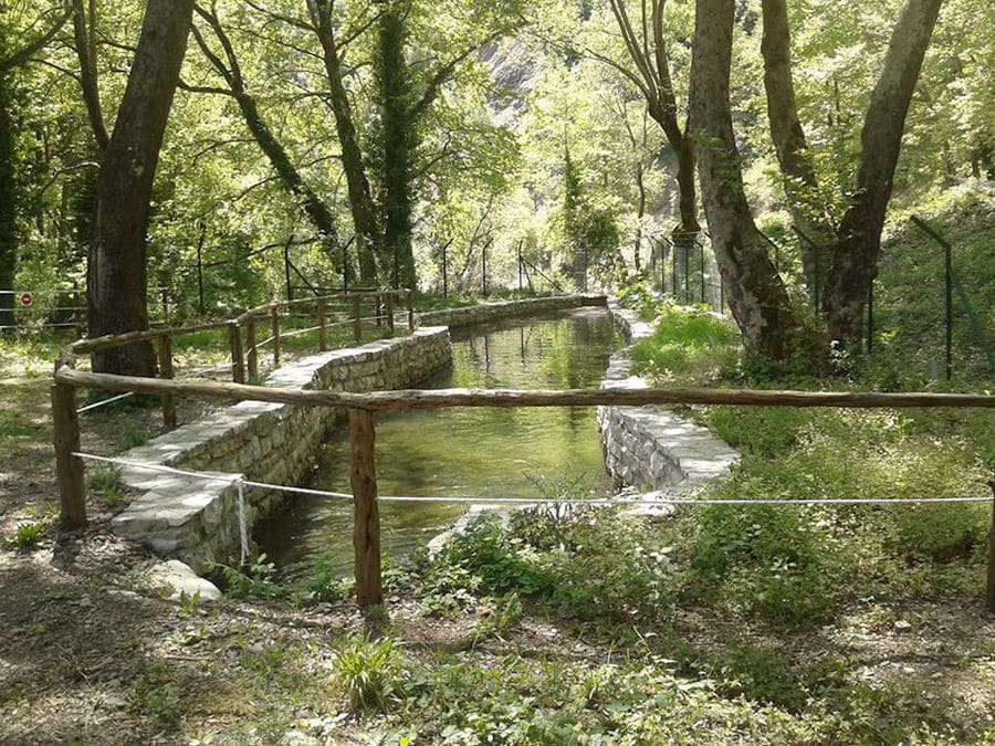 brook between stone terraces and wooden handmade railings surrounded by forest at 'Fresko'