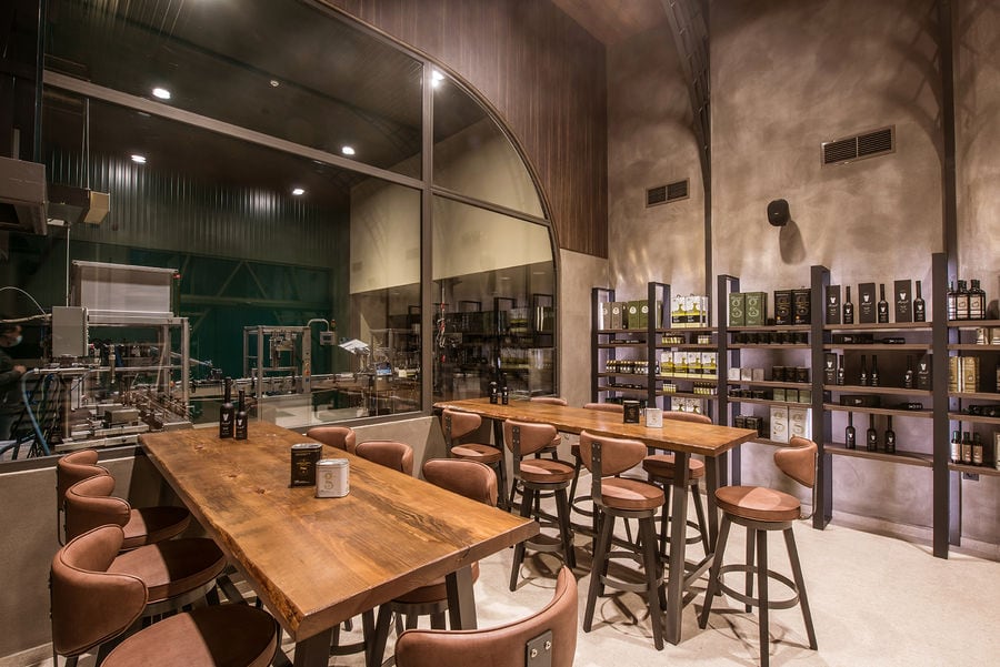 Savouidakis' Olive Oil Tasting Area, with 2 large tables and chairs.