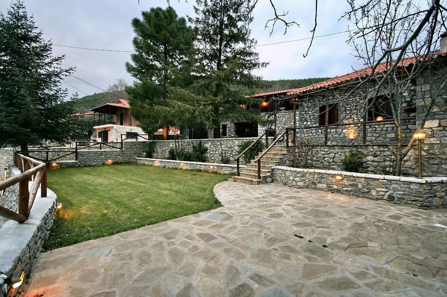 one side of Kalogris Winery stone building with pavement and green lawn in the front