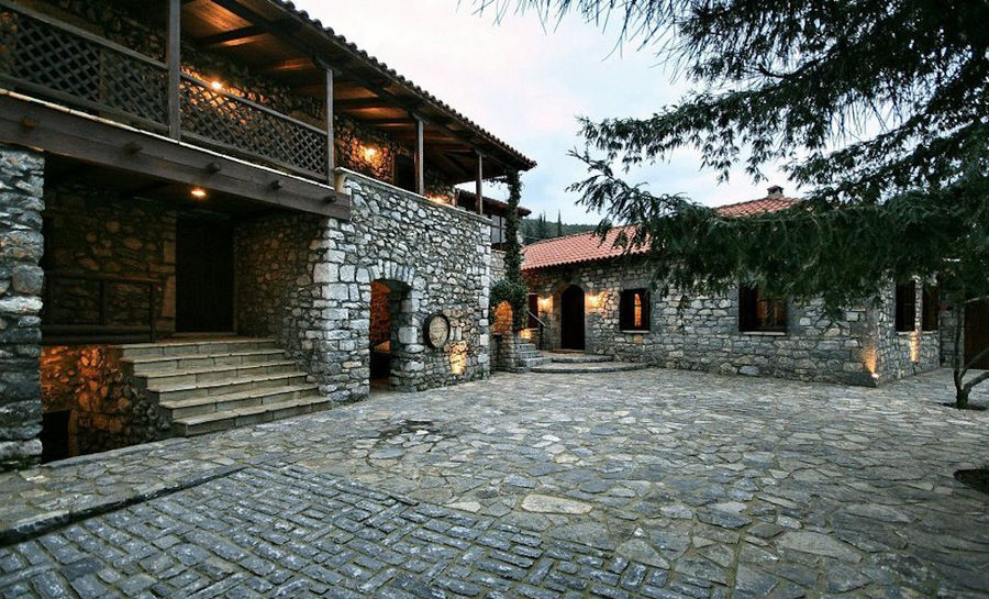 one side of Kalogris Winery stone building with pavement in the front