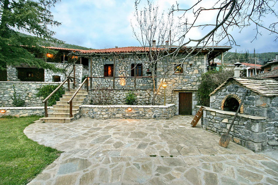 one side of Kalogris Winery stone building with pavement and green lawn in the front