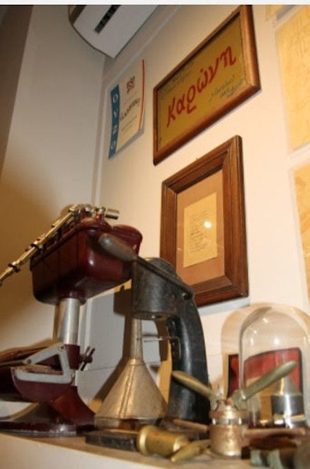 old copper tools and exhibits and framed awards on the wall of Karonis Distillery museum