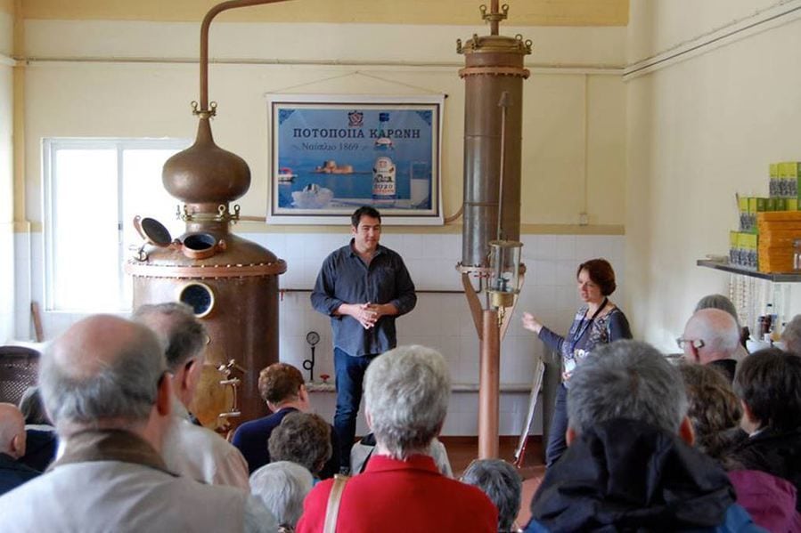 tourists listening to a guide at Karonis Distillery museum